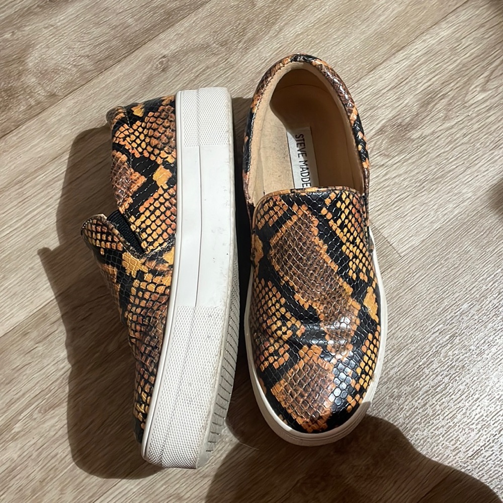 Orange and black snake skin Steve Madden shoes.